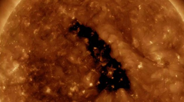 A vibrant image of a solar flare on the sun, with intense colors ranging from red to yellow, captured by NASA's Solar Dynamics Observatory, illustrating the sun's dynamic and powerful nature.